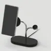 A black wireless charging stand with a silver arm holding a smartphone. Podgląd zdjęcia produktu