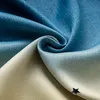 A close-up shot of draped fabric with a gradient color pattern and star shapes. Voir les images du produit