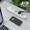 A white power strip with multiple outlets is connected to a black plug, and a smartphone is charging on a desk next to a laptop. Voir les images du produit