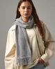 A woman wearing a scarf and jacket. Produktbild-Vorschau