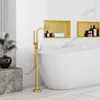 A modern bathroom with a freestanding bathtub and a gold-colored faucet. Produktbild-Vorschau