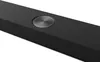 A close-up, angled view of the top surface of a black soundbar. Voir les images du produit