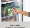 A person's hand pulling out a drawer from a freezer filled with frozen food. Náhled obrázku produktu