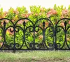 A black metal garden fence in front of a hedge with pink flowers and green leaves. Náhľad obrázku produktu