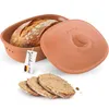 A terracotta bread baking dish with a loaf of bread inside, its lid, and three slices of bread in front. Produktbild-Vorschau