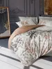A bedroom scene with a bed dressed in bedding with a floral pattern, a mirror, and decorative wall molding. Produktbild-Vorschau