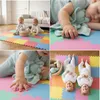 A collage of four images showing babies playing on a colorful puzzle mat, sleeping, and interacting with toys. Produktbild-Vorschau