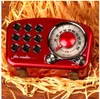 A vintage-style red FM radio is displayed on a bed of shredded yellow paper. Produktbild-Vorschau