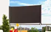 A balcony scene with a retractable awning, drinks, and greenery. Produktbild-Vorschau