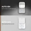 Two images showing a plug-in LED night light. The top image shows the light on in a dark room, and the bottom image shows it off in a brighter room. Produktbild-Vorschau