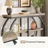 A console table with decorative items on it, set against a wall with framed pictures and a plant. Podgląd zdjęcia produktu