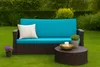 A garden bench with cushions and a coffee table set up on a lawn. Náhľad obrázku produktu