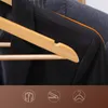 Close-up of black and grey suits hanging on wooden hangers. Produktbild-Vorschau