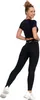 A woman wearing black leggings and a black crop top, posing against a white background. Produktbild-Vorschau