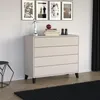 A chest of drawers with decorative items on top, placed in a room with framed pictures on the wall. Produktbild-Vorschau