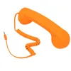 An orange retro telephone handset with a coiled cord and a 3.5mm jack is shown against a white background. Náhled obrázku produktu