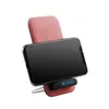 A smartphone is placed on a pink wireless charger stand. Produktbild-Vorschau