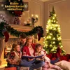 A family is gathered around a Christmas tree, reading a book. Anteprima dell’immagine prodotto