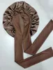A brown satin bonnet with ties is laid out on a white background. Podgląd zdjęcia produktu