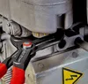 A close-up shot of Knipex Cobra QuickSet water pump pliers gripping a bolt on a piece of machinery. Anteprima dell’immagine prodotto