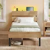 A bedroom scene with a bed, nightstand, and robot vacuum. Produktbild-Vorschau