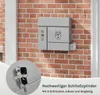A gray mailbox with an owl design is mounted on a brick wall. A close-up of keys and a lock is shown in a circular inset at the bottom left. Text describing the lock is present. Produktbild-Vorschau
