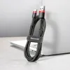 A black and red USB/USB-C charging cable is coiled and held together by a strap with the brand name on it, resting on a laptop. Náhľad obrázku produktu