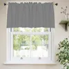 A gray valance curtain is hung over a white-framed window. The window looks out onto a green, leafy outdoor scene. A small plant is visible on a shelf to the right. Produktbild-Vorschau