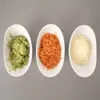 Three white oval dishes filled with grated ingredients: green (likely herbs or vegetables), orange (carrots), and white (cheese or breadcrumbs). Náhľad obrázku produktu
