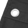 A close-up view of a black fabric with a metal grommet. Anteprima dell’immagine prodotto