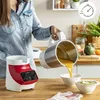 A person is pouring soup from a blender into a bowl in a kitchen setting. Voir les images du produit