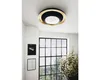 A modern living room with a large window and a decorative ceiling light. Náhled obrázku produktu