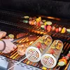 A person is grilling vegetables and meat on a barbecue. Náhled obrázku produktu