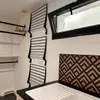 A laundry room with wall-mounted drying racks and a sink. Produktbild-Vorschau