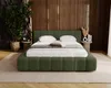 A bedroom scene featuring a green upholstered bed. Náhled obrázku produktu