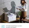 A woman is standing next to an HP printer, holding papers. Podgląd zdjęcia produktu
