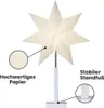 A white star-shaped lamp on a white stand, with close-up insets highlighting its paper material and base. Podgląd zdjęcia produktu