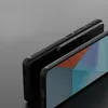 A close-up shot of two black phone cases, one slightly behind the other, on a gray background. Podgląd zdjęcia produktu