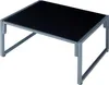 A modern coffee table with a black glass top and a gray metal frame, presented on a white background. Anteprima dell’immagine prodotto