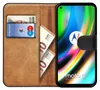 A book-style phone case with a Motorola Moto G9 Plus phone inserted, showing cards and banknotes in the case's slots. Náhľad obrázku produktu
