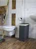A bathroom scene with a toilet, sink, laundry basket, and ladder. Náhľad obrázku produktu