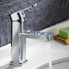 A modern chrome faucet with water running into a sink, with a bar of green soap on a wooden soap dish in the background. Podgląd zdjęcia produktu