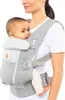 A woman is wearing a baby carrier with a baby in it. Anteprima dell’immagine prodotto