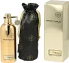 A gold perfume bottle, a black drawstring pouch with gold logos, and a gold product box are displayed. Podgląd zdjęcia produktu