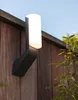 An outdoor wall lamp mounted on a wooden fence. Produktbild-Vorschau