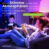 A couple relaxing on a couch in a dimly lit room with colored lighting, one person reading a book and the other using a tablet. Produktbild-Vorschau