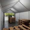 A forklift is moving pallets of wooden planks inside a large tent-like structure. Náhled obrázku produktu