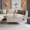 A modern living room scene featuring a sectional sofa and a coffee table. Produktbild-Vorschau