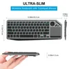 A hand holding a slim wireless keyboard with a touchpad, with dimensions and text overlays indicating its features. Produktbild-Vorschau