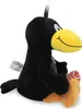 A plush toy raven sitting and holding a candy. Produktbild-Vorschau